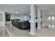 Expansive living room with stone floors, columns, recessed lights, and a large leather sofa at 6419 Eldora Ave, Las Vegas, NV 89146