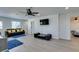 Spacious living room boasts light gray floors and ample space for entertaining guests and activities at 6419 Eldora Ave, Las Vegas, NV 89146