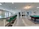 Spacious living room featuring a long bar, pool table, and open layout with bright lighting at 6419 Eldora Ave, Las Vegas, NV 89146