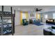 Bright living room with gray floors, modern decor, and plenty of seating at 6419 Eldora Ave, Las Vegas, NV 89146