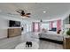 Large main bedroom suite with ceiling fan, dresser, french doors, and multiple seating areas at 6419 Eldora Ave, Las Vegas, NV 89146