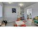 Cozy playroom featuring a crafting table, shelves, and access to the well-lit bathroom at 6419 Eldora Ave, Las Vegas, NV 89146