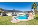 Backyard pool area featuring palm tree, diving board, concrete patio, and a single-story home with solar panels at 6419 Eldora Ave, Las Vegas, NV 89146