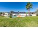 Beautiful backyard pool, palm tree, lounge chairs, and outdoor seating area in front of a single-story home at 6419 Eldora Ave, Las Vegas, NV 89146