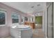 Well-lit bathroom with a soaking tub, double sinks, and separate shower at 6424 Grayback Dr, North Las Vegas, NV 89084