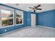 Bedroom featuring tile flooring, a ceiling fan, natural light, and a door at 6424 Grayback Dr, North Las Vegas, NV 89084