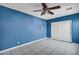 Cozy bedroom showcasing tile flooring, a ceiling fan, and a closet at 6424 Grayback Dr, North Las Vegas, NV 89084