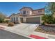 Two-story home with a two-car garage, neutral palette and low-maintenance landscaping at 6424 Grayback Dr, North Las Vegas, NV 89084