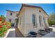 Home featuring sidewalk, three potted plants and arched windows at 6424 Grayback Dr, North Las Vegas, NV 89084