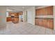 Spacious kitchen with wood cabinets, granite countertops, and a center island at 6424 Grayback Dr, North Las Vegas, NV 89084