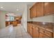 Well-lit kitchen featuring wooden cabinets, granite countertops, and a kitchen island at 6424 Grayback Dr, North Las Vegas, NV 89084