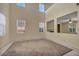 Sun-filled living room with large windows and plush carpeting, creating a warm and inviting atmosphere at 6424 Grayback Dr, North Las Vegas, NV 89084