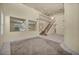 Bright and airy living room with tile flooring, staircase, and ample space for entertaining guests at 6424 Grayback Dr, North Las Vegas, NV 89084