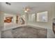 Open-concept living room with fireplace connected to kitchen and staircase at 6424 Grayback Dr, North Las Vegas, NV 89084