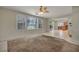 Bright living room featuring large windows and an open view of the kitchen at 6424 Grayback Dr, North Las Vegas, NV 89084