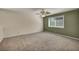 Open loft area with a ceiling fan and a large window overlooking the backyard at 6424 Grayback Dr, North Las Vegas, NV 89084