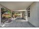 Covered outdoor patio featuring an outdoor fan and lush landscaping at 6424 Grayback Dr, North Las Vegas, NV 89084