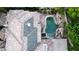 Drone eye view of tile roof and pool with waterfalls in luxurious backyard at 764 Ricota Ct, Henderson, NV 89012