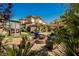 Beautiful backyard with custom landscaping, play structure and outdoor seating at 764 Ricota Ct, Henderson, NV 89012