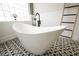 Bright bathroom with a modern standalone tub and stylish black and white tile at 764 Ricota Ct, Henderson, NV 89012