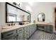 Bathroom featuring dual sinks, stylish cabinetry, and patterned tile flooring at 764 Ricota Ct, Henderson, NV 89012