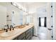 Elegant bathroom features double sinks, framed mirror and neutral color palette at 764 Ricota Ct, Henderson, NV 89012