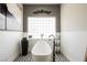 Bright bathroom with a modern standalone tub and stylish black and white tile at 764 Ricota Ct, Henderson, NV 89012