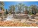 Stunning water feature at the Roma Hills entrance, showcasing cascading waterfalls and lush greenery at 764 Ricota Ct, Henderson, NV 89012