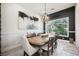 Elegant dining room with large windows, stylish chandelier, and a large wood table at 764 Ricota Ct, Henderson, NV 89012