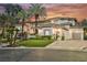 Stunning multi-story home with lush landscaping, palm trees, and a long driveway at 764 Ricota Ct, Henderson, NV 89012