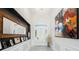 Elegant foyer with detailed millwork, wood-look tile flooring, designer lighting, and a large decorative mirror at 764 Ricota Ct, Henderson, NV 89012