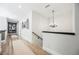 Upstairs hallway with chandelier lighting and art at 764 Ricota Ct, Henderson, NV 89012