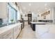Modern kitchen features a large window over the sink, white cabinets, and stainless steel appliances at 764 Ricota Ct, Henderson, NV 89012