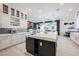 Bright, modern kitchen with a large island, white cabinetry, and stainless steel appliances at 764 Ricota Ct, Henderson, NV 89012