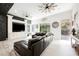 Spacious living room with a cozy leather sofa, TV, and access to outdoor patio at 764 Ricota Ct, Henderson, NV 89012