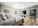 Bright bedroom featuring a chandelier, balcony access, and wood-look floors at 764 Ricota Ct, Henderson, NV 89012