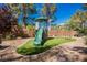 Backyard play structure with slide, climbing wall and swings surrounded by turf at 764 Ricota Ct, Henderson, NV 89012