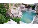 Backyard pool boasts rock waterfalls and lush greenery, creating a private, tranquil oasis at 764 Ricota Ct, Henderson, NV 89012