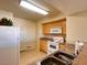 Traditional kitchen with wood cabinets, white appliances, and a stainless steel sink at 8000 Badura Ave # 2009, Las Vegas, NV 89113