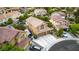 Aerial view of a home with a private pool, neutral-toned exterior, three-car garage, and well-manicured front yard landscaping at 8253 Ruby Mountain Way, Las Vegas, NV 89128