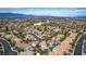 High-angle aerial view of the property within a beautiful community, featuring mature trees and private backyard pools at 8253 Ruby Mountain Way, Las Vegas, NV 89128