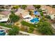 Expansive aerial view of a property with a pool, spa, and lush landscaping in a residential neighborhood at 8253 Ruby Mountain Way, Las Vegas, NV 89128