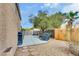 Backyard showcasing an outdoor grill area, gravel landscaping, and privacy fencing at 8253 Ruby Mountain Way, Las Vegas, NV 89128