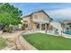 Lush backyard featuring a pool, outdoor seating, green space, and pergola for outdoor enjoyment at 8253 Ruby Mountain Way, Las Vegas, NV 89128