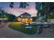 Expansive backyard featuring a well-maintained lawn, pool, spa, and shaded seating area at 8253 Ruby Mountain Way, Las Vegas, NV 89128