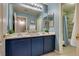 Bathroom with a double sink vanity with cabinets and a tiled shower at 8253 Ruby Mountain Way, Las Vegas, NV 89128