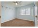 Bright bedroom features a ceiling fan, window with blinds, and neutral carpeting at 8253 Ruby Mountain Way, Las Vegas, NV 89128