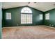 Large bedroom with carpet flooring, vaulted ceilings, and many windows at 8253 Ruby Mountain Way, Las Vegas, NV 89128