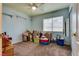 Light-filled bedroom with a ceiling fan, open shelves, and a window with lots of storage at 8253 Ruby Mountain Way, Las Vegas, NV 89128
