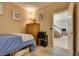 Bedroom with natural lighting, hardwood furniture, and adjacent access to the staircase at 8253 Ruby Mountain Way, Las Vegas, NV 89128